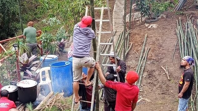 Local Filipinos building traditional bamboo structure for town fiesta Philippines