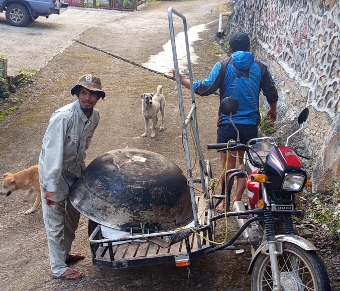 Filipino doing bayanihan community work in rural Philippines village