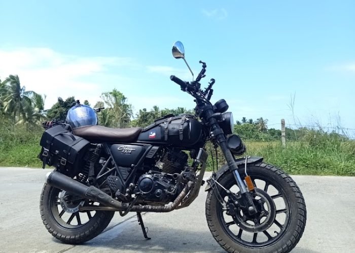 Motorbike parked on a scenic road in Palawan, Philippines with jungle and blue sky